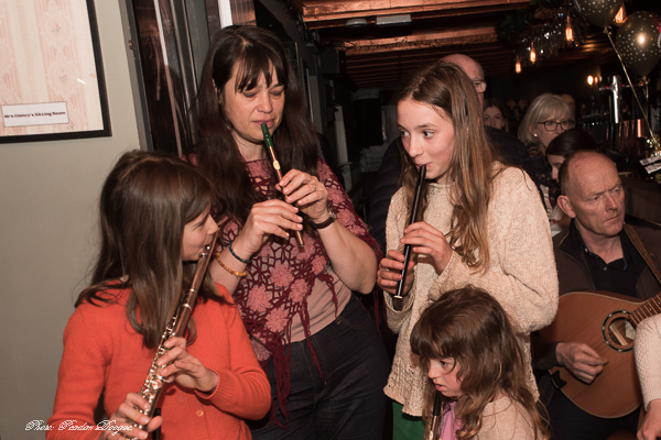 Three flute players at a Clancy's trad session