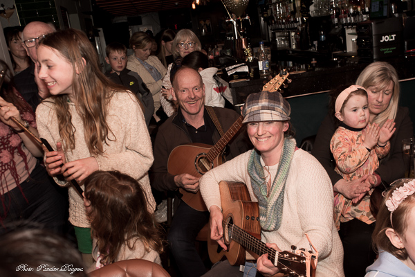 A guitarist leading a singalong with the crowd